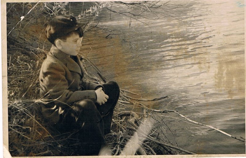 Boy sitting by the Szamos River